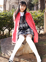 Japanese tramp poses in her school uniform as she waits