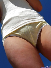 Asian babe Asuka shows off her great tits in the sun